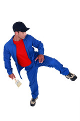 A male painter kicking.
