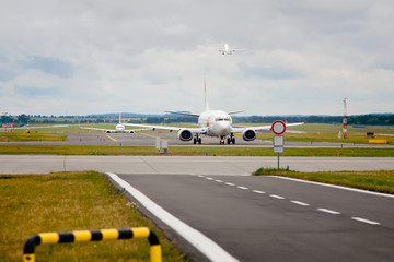 Front view on airplanes taxiing to the runway