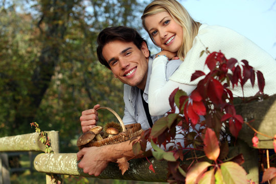 Couple with basket of mushrooms