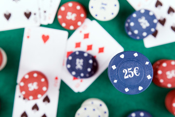 Poker chips and cards on a green felt