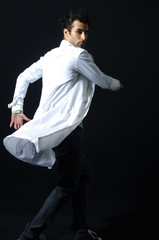 Hip-hop style dancer posing on a black background