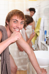 Three male housemates in bathroom