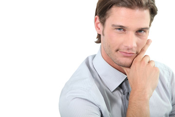 Young businessman holding chin