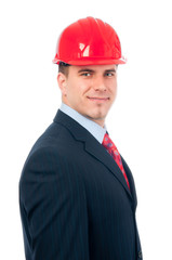 Portrait of handsome smiling engineer with red hardhat