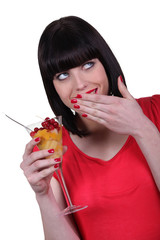 Woman eating a fruit salad