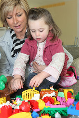 Little girl playing with her grandmother