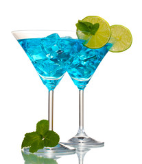 Blue cocktail in martini glasses with ice isolated on white