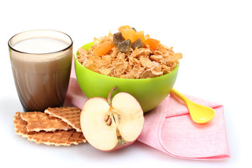 tasty cornflakes in green bowl and glass of milk isolated