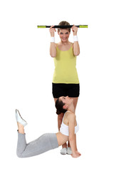 two girlfriends training together in the gym