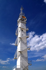 Fototapeta premium white lighthouse on cloudy background