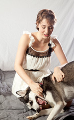 pretty woman with her pet husky dog