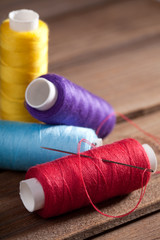 coloured bobbins of thread