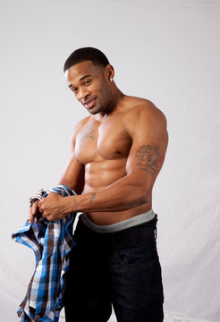 strong man toopless, looking at the camera