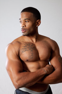 strong man toopless, arms crossed
