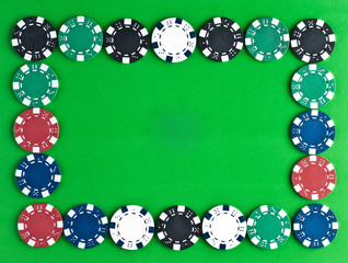 Counters and playing cards on a green background