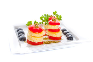 cheese and a tomato with sauce.
