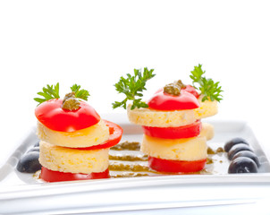 cheese and a tomato with sauce.