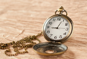an old vintage pocket watch on grungy paper