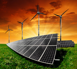 Solar panels and wind turbine in the setting sun