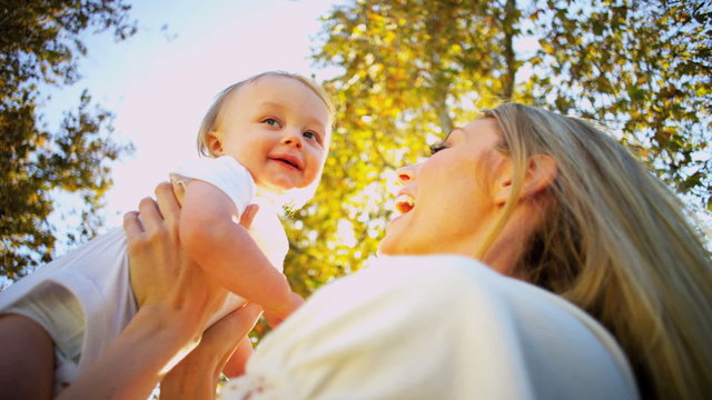 Blonde Mom and Baby Laughing Outdoors