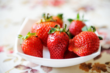 Plate of strawberries on a table cloth