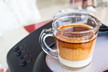 A cap of coffee on coffee machine,outdoor