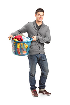 Full Length Portrait Of A Man Holding A Laundry Basket