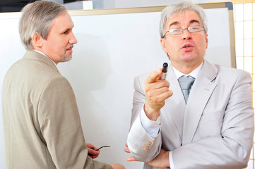 Obraz premium Closeup of two mature smiling business men