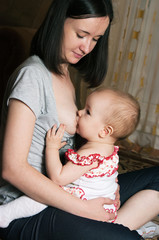 mother breast feeding baby