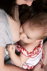 mother breast feeding baby