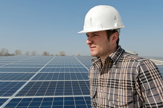 Worker in front of a photovoltaic plant