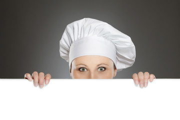 Female chef looking over  billboard