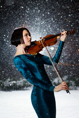 Girl with voilin on snow