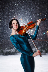 Girl with voilin on snow