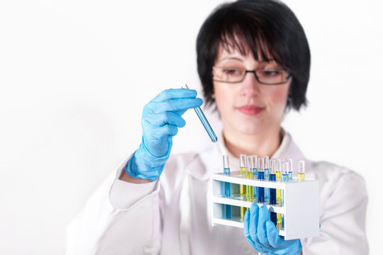 A female scientific researcher looking at a liquid solution.