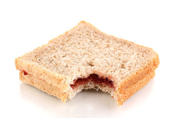 Fototapeta na wymiar Bitten sandwich with jam isolated on white