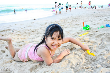 cute girl playing on beach