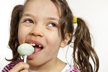 Close-up of little girl with a lollipop