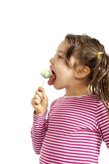 portrait of little girl with a lollipop on white background