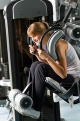 Young woman at fitness center exercise abdominal