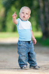 Happy little boy in the green park