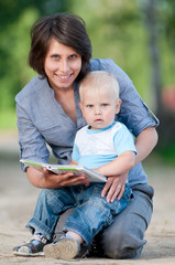 Mother with son reading a book