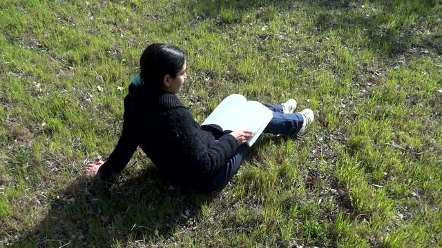 girl studying on the meadow