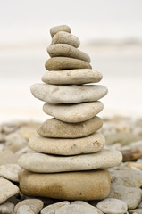 Fototapeta na wymiar pile of stones balanced at winter beach