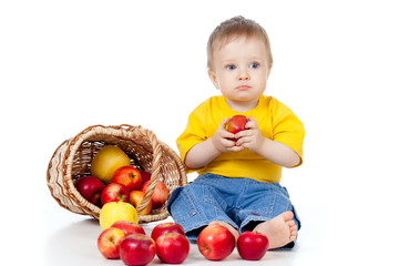 Fototapeta na wymiar Little boy with healthy food. Near basket with apples.