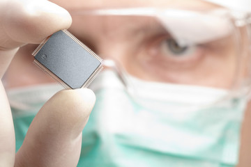 Scientist examining a microchip