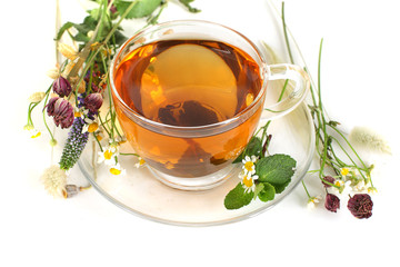 Tea and flowers on white background