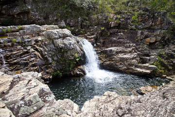 Small waterfall and lake with rocks