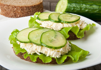 Healthy sandwich with cucumber and egg with cheese for breakfast