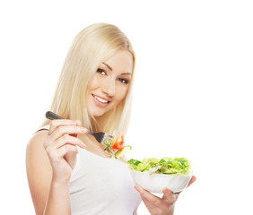 A young blond woman holding a fresh green salad